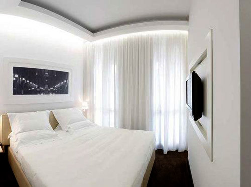 Оформлення дизайну маленької спальні в білому кольорі прекрасно візуально збільшує кімнату